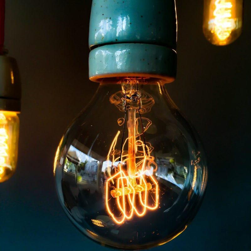 turned on clear glass light bulb
